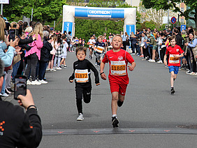 Zieleinlauf zweier Jungs des Schülerlaufs