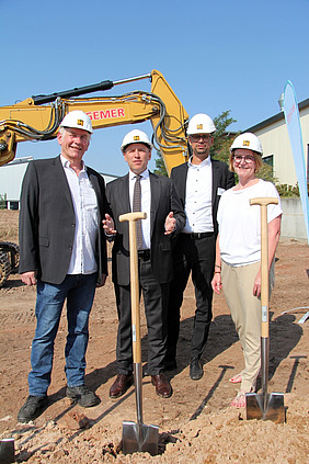 MKU-Geschäftsführer Ernstjürgen Klapp (v. l.), der Hessische Minister für Bundes- und Europaangelegenheiten, Manfred Pentz, der kaufmännische MKU-Leiter Thorsten Schrod und Erste Stadträtin Andrea Schülner mit Bauhelm und Spaten.